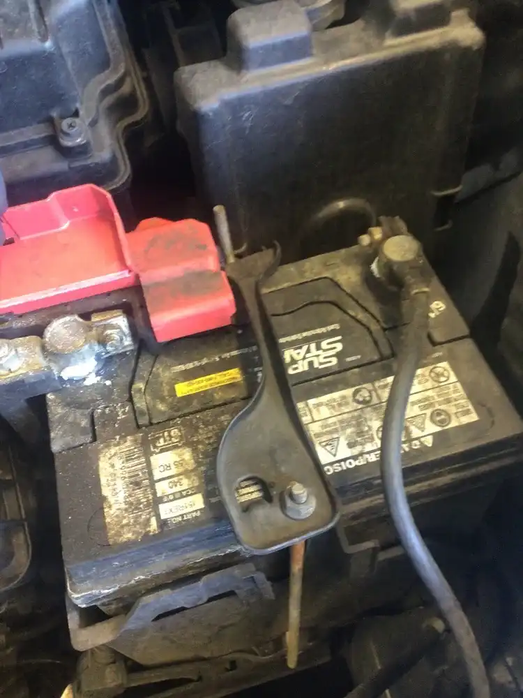 Corroded battery terminals — classic intermittent electrical fault source on older vehicles in the Bay Area, photographed at Beacon Auto Care San Mateo