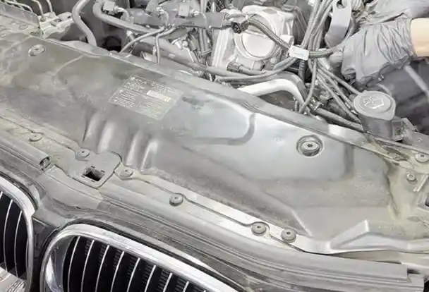 BMW 550i with hood up showing the kidney grille and N62 4.8L V8 engine bay at Beacon Auto Care San Mateo