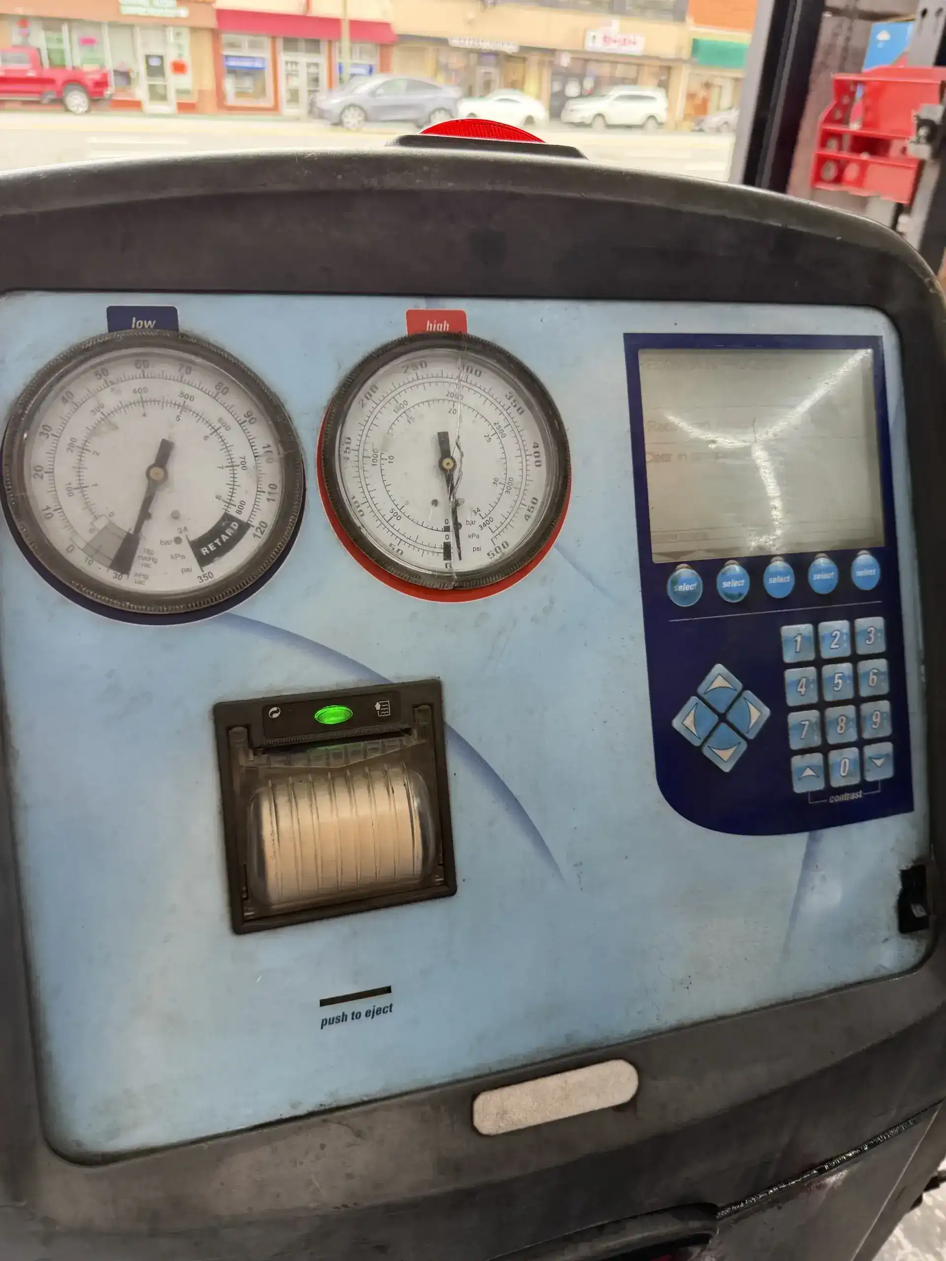 Robinair AC machine gauges showing high-side and low-side pressure readings at Beacon Auto Care San Mateo