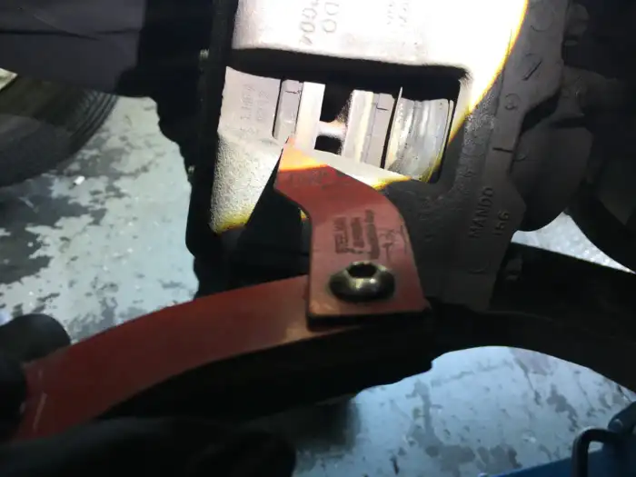 Brake pad gauge showing 1mm of friction material left on the front pads of a 2013 Hyundai Sonata during a digital vehicle inspection in San Mateo