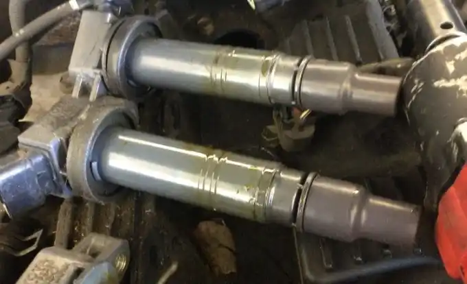 Worn, oil-fouled spark plugs pulled during a digital vehicle inspection at Beacon Auto Care San Mateo